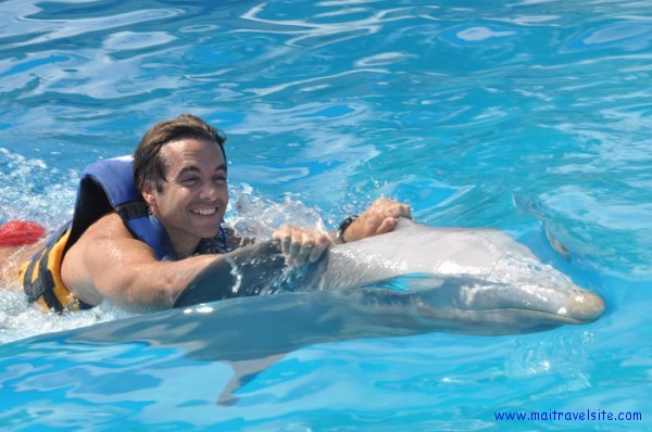 Belly riding a dolphin