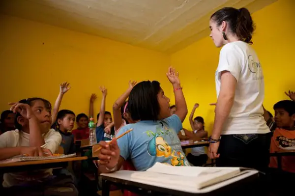 A volunteer with children in class